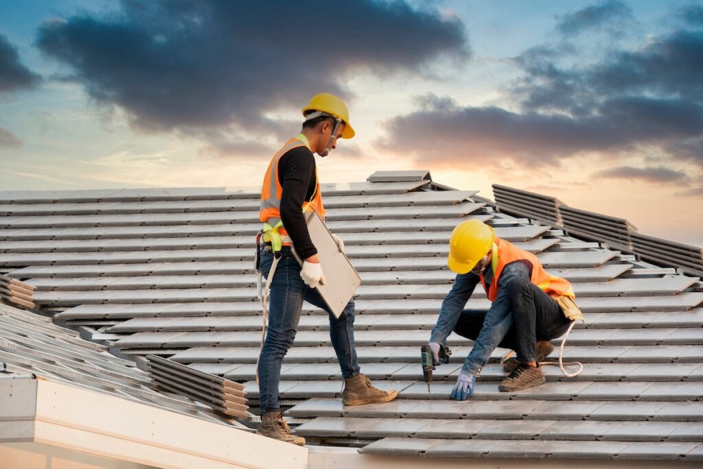 Roofer installing metal commercial roofing solution